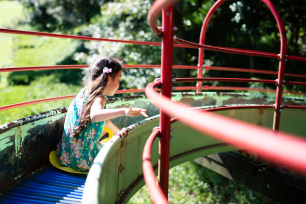 istock Girl play on the slide 1050702490