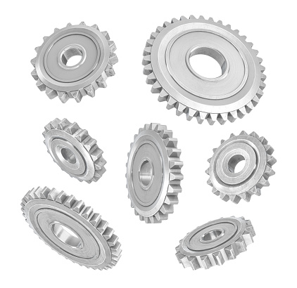 3d rendering of several metal spur gears hanging in different angles on a white background. Mechanical parts. Equipment internal parts. Changing gears.