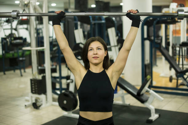 istock Young woman exercising in gym 1050706360