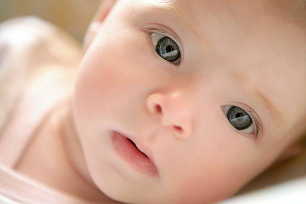 istock Blond little baby laying on bed portrait 105071248