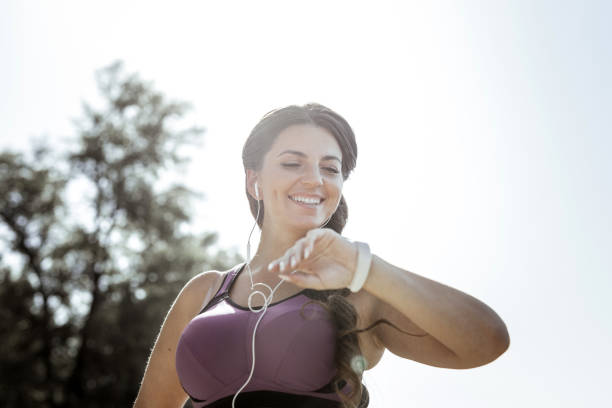 istock Low angle of a happy nice woman checking the time 1050715026