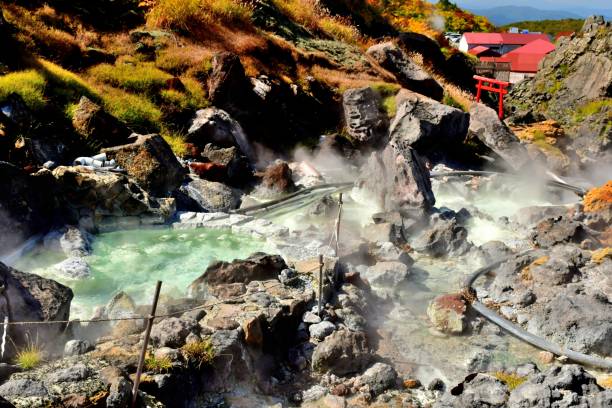 Source of Hot Spring Water at Sugawa Plateau, Mt Kurikoma Higashi Naruse Village, Akita Prefecture, Japan-
October 3, 2018:
The source of hot spring water is gushing out with the smell of sulphur in Sugawa Plateau; one of the starting points of trail up to Mt Kurikoma. 
Autumn colors of Sugawa Plateau (1100-1300 meter high), which is a part of Mt Kurikoma located on the border of Miyagi, Iwate and Akita Prefectures in northeastern Japan. The mountain is famous for its beautiful autumn foliage, consisting of beech, rowan, maple and other alpine trees. Mt Kurikoma is a volcano with the height of 1626 meters. Lake Showa was created after the volcanic eruption of 1944. shinto stock pictures, royalty-free photos & images