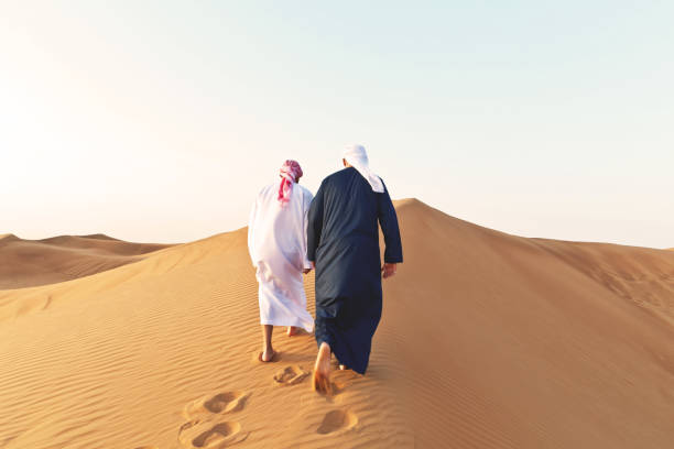 istock Friends going up a large dune together. 1050716518