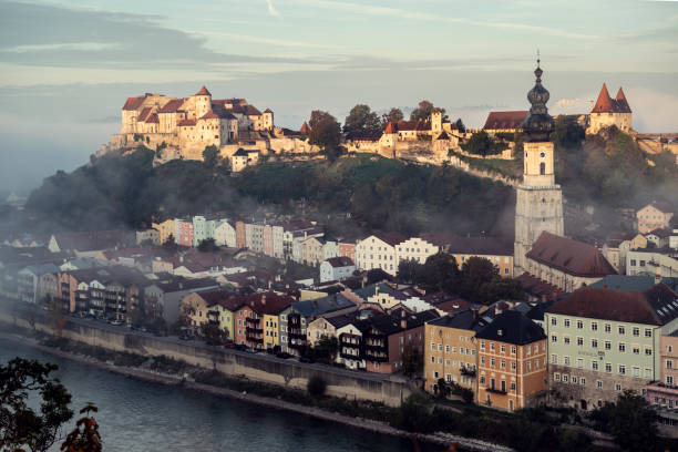 Burghausen, Bavaria, Germany. City and castle of Burghausen seen from the Austrian side of the River Salzach at early autumn morning. Burghausen Castle in Burghausen, Upper Bavaria, is the longest castle complex in the world (1051 m).