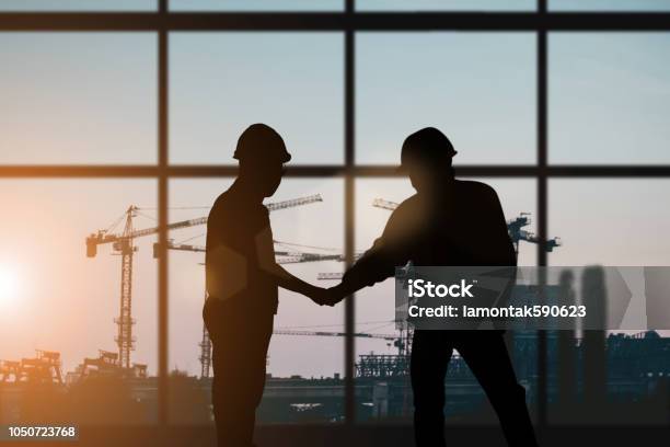 Silhouette Of Engineer And Construction Team Working At Site Over Blurred Background For Industry Background With Light Faircreate From Multiple Reference Images Together Stock Photo - Download Image Now