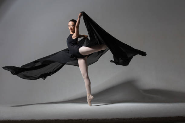 istock Graceful ballerina in dance with black cloth 1050726462