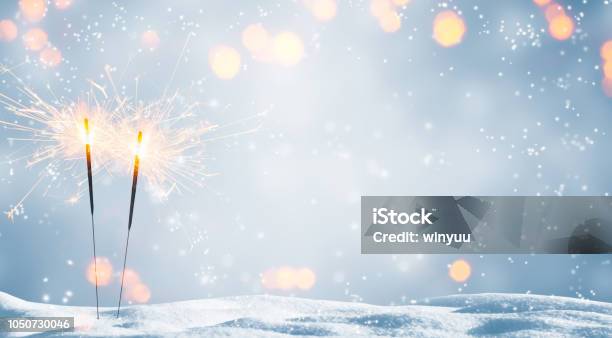 Two Burning Sparklers In Snow Stock Photo - Download Image Now - New Year's Eve, Winter, Backgrounds