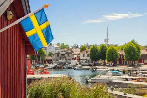 A swedish flag by the harbor in the village of Sandhamn on Sandön (island) in Stockholm archipelago.