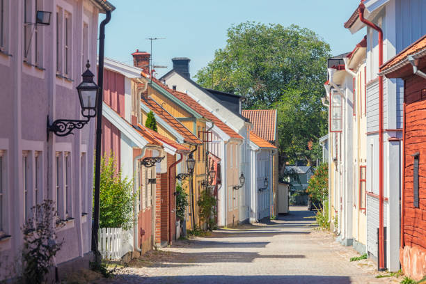 Old streets of Vadstena A street with old wooden houses in the historical town of Vadstena in Östergötland, Sweden. ostergotland stock pictures, royalty-free photos & images