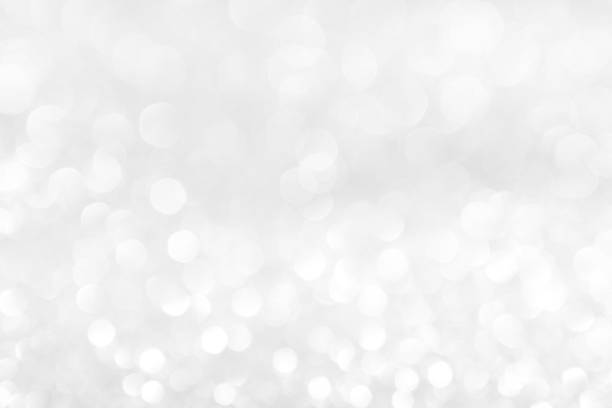 istock abstract background white Silver lights on christmas bokeh 1050734082