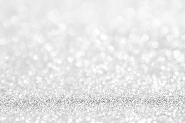istock abstract background white Silver lights on christmas bokeh 1050736206
