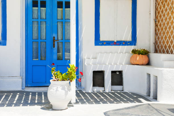 istock Traditional greek white architecture with blue doors and windows. 1050739940