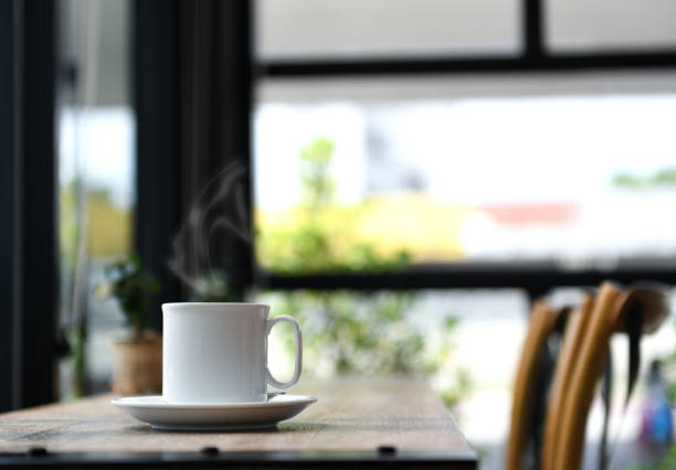 istock Coffee with smoke on wooden table. 1050745554