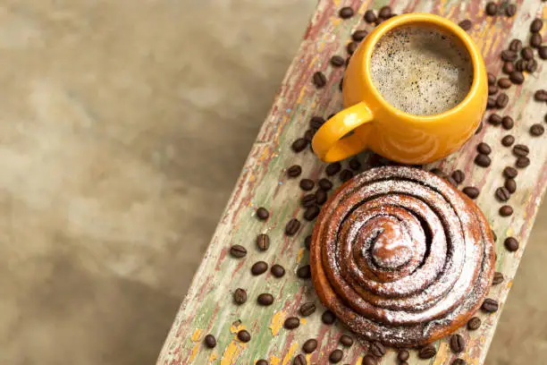 A cup of fragrant coffee with a sweetest kanelbulle. Copy-space.