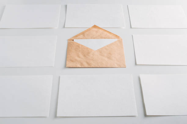 istock White paper empty sheets cards and kraft envelope on a white background. Mockup for design 1050746374