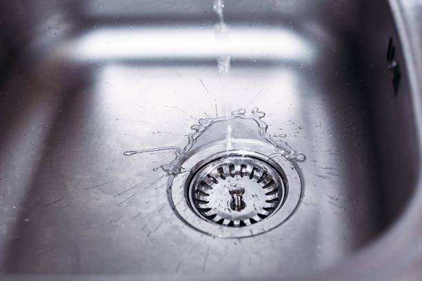 istock Water running from the tap to kitchen sink. Fresh water saving concept 1050746480