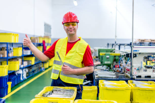 istock Happy engineer shows thumbs up inside of a factory. 1050749208