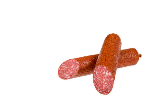istock smoked salami sausage piece isolated on white background, copy space template 1050761080