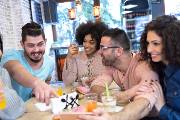 istock Young people enjoying time together in cafeteria 1050763132