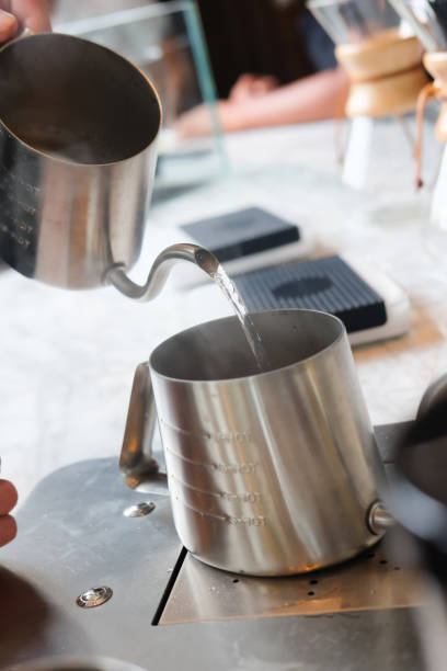 istock Professional barista pouring hot water on cup 1050763318
