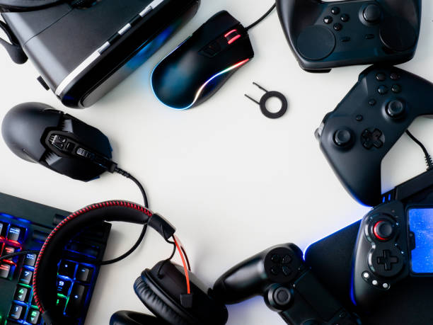 gamer workspace concept, top view a gaming gear, mouse, keyboard, joystick, headset and mouse pad on white table background.