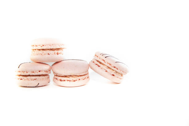 Delicious stack of four pink macrons on white background
