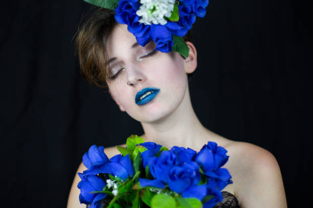 istock Sensual woman with blue flowers 1050764494
