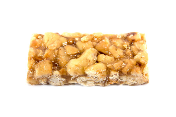 istock Caramel peanuts bar isolated on white background. Honey brittle peanuts isolated 1050768468