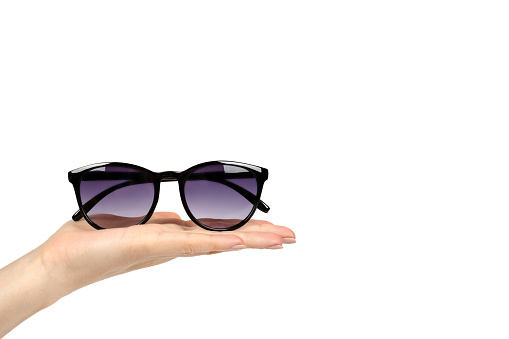 Stylish plastic sunglasses with hand isolated on white background, copy space template.