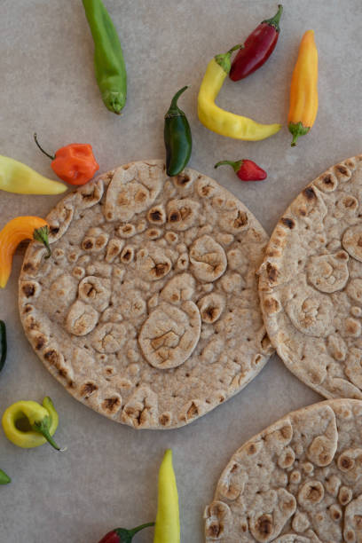 istock Naan Indian flat bread with colorful chili peppers 1050773014