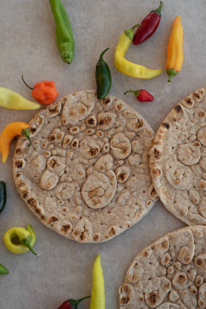 istock Naan Indian flat bread with colorful chili peppers 1050773062