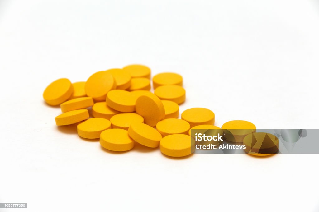 many yellow pills on white background yellow pills on white background. vitamins Capsule - Medicine Stock Photo