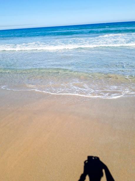 istock Empty sand beach with blue sea and blue sky background. 1050783908