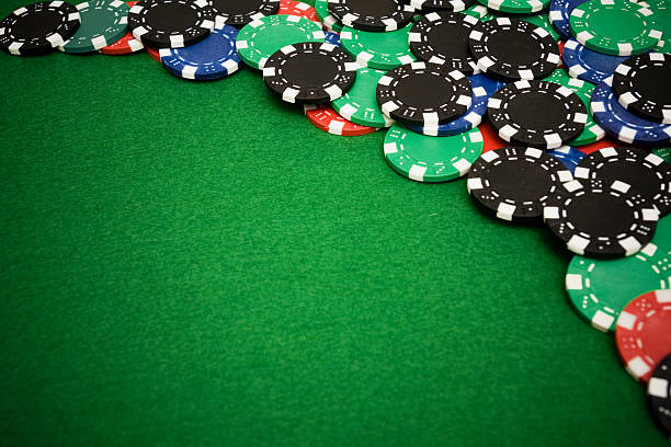 istock Colorful gambling chips on green felt with copy space 105078425