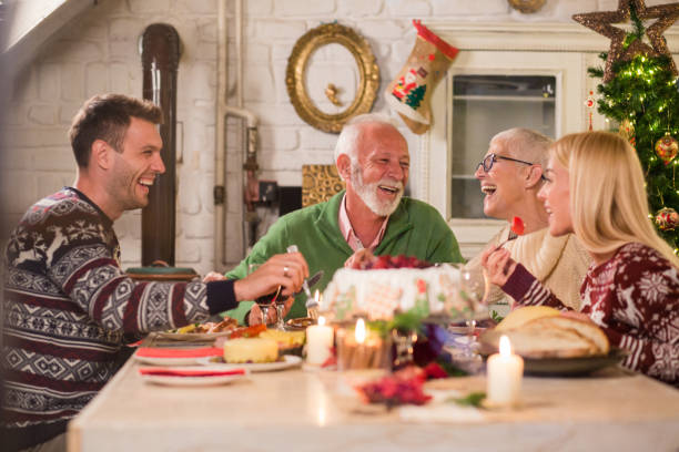 istock Family smiling over Christmas dinner 1050784594