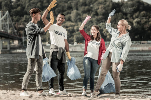 istock Happy beaming volunteers giving high five to each other after completing the tasks 1050789366