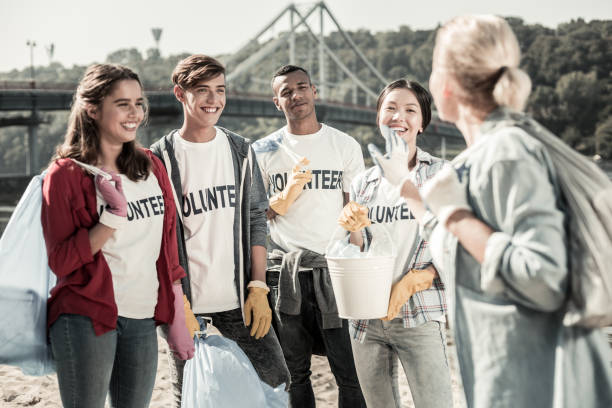 istock Blonde-haired teacher feeling thankful to her students participating in volunteering 1050789614