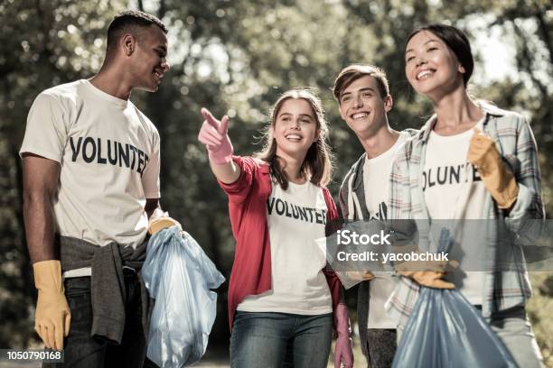 Smiling Young Pupils Feeling Involved In Cleaning Up The Forest And Volunteering Stock Photo - Download Image Now