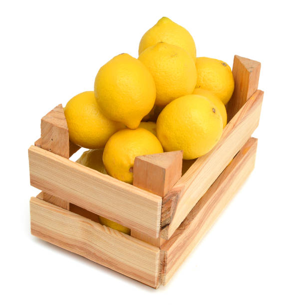 istock fresh lemons in a wooden box on a white background 1050790342