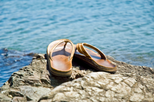 These leather sandals are sitting on the rocks, overlooking Lake Cowichan, BC.