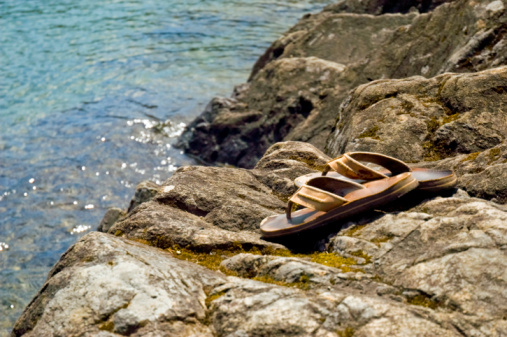 These Leather Sandals are sitting on some rocks alongside the waters of Lake Cowichan, BC.