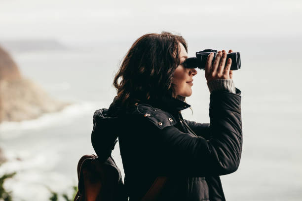 istock Female hiker enjoying spectacular view through binoculars 1050810094