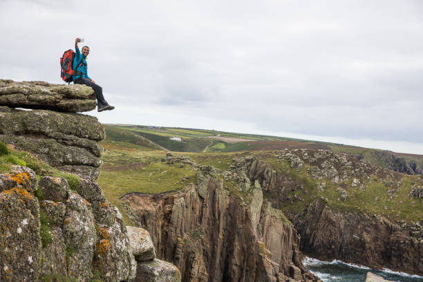 istock Traveler exploring the rocky coastline in Cornwall, UK 1050810398