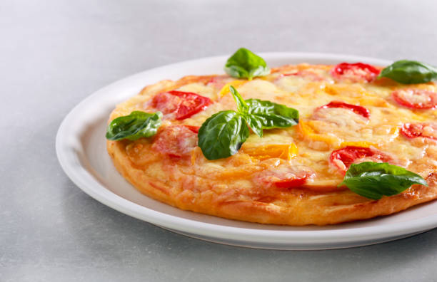 istock Fresh homemade pizza with basil on top, 1050813532