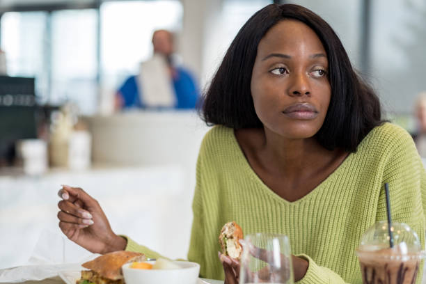 istock Young black woman at lunch 1050814330