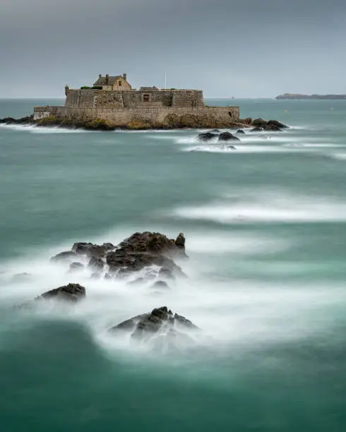 Long Exposure of the sea and Fort National in Saint Malo (France) on a stormy day in summer