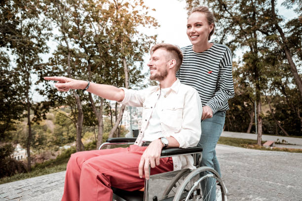 istock Disabled man feeling happy while showing the park to his pretty girlfriend 1050821242