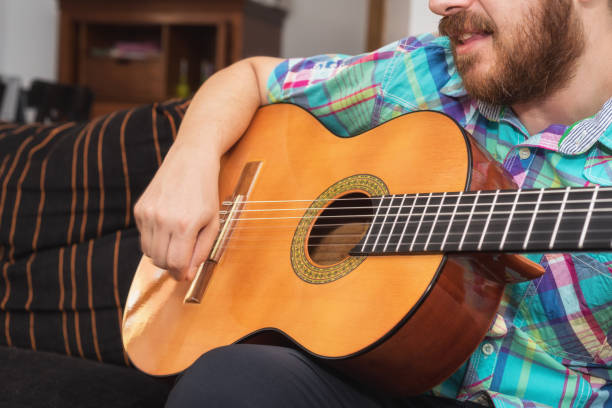 istock Young man musician playing acoustic guitar 1050822346