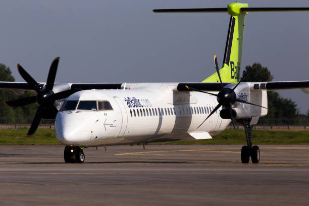 yl-bax air baltic de havilland canada dhc-8-400 aircraft running on the parking area at borispol international airport - fuel and power generation air vehicle repairing airplane imagens e fotografias de stock