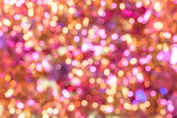 Photo of Background texture full of unsharp golden and pink shining bokeh blurring gradation design.